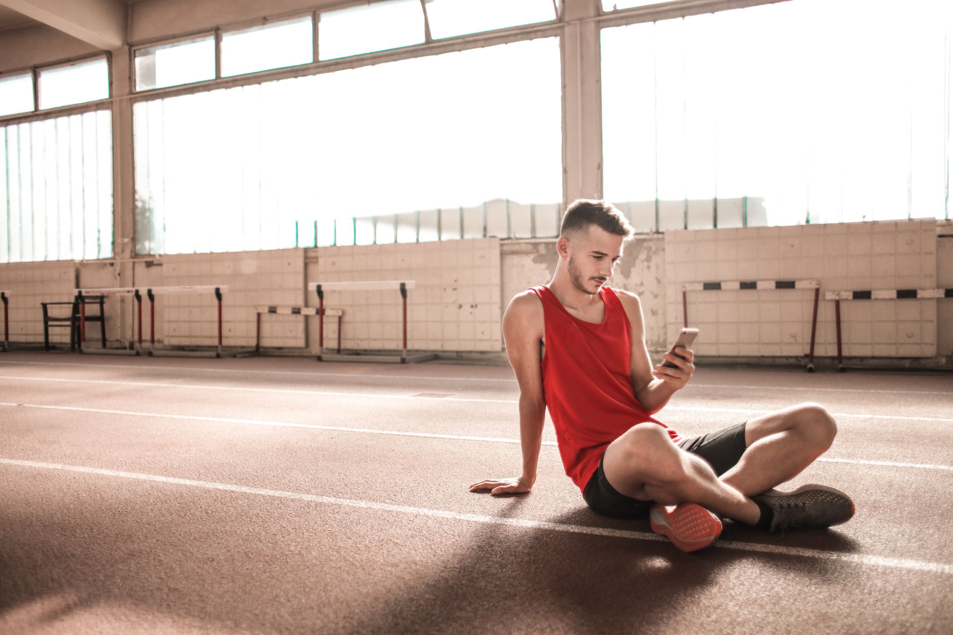 Athlete checking a training app on a phone before a workout.