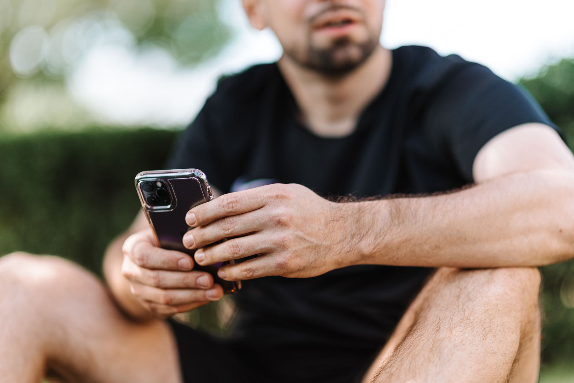 Athlete checking a fitness app on a phone for Best AI credit model for training software buyers.