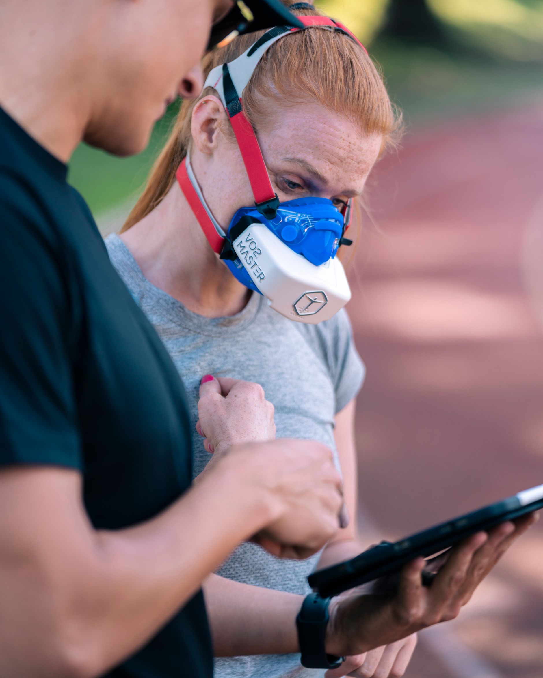 Athlete reviewing performance data with a coach for private AI endurance coaching.